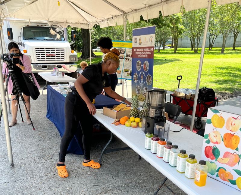 Shardai setting up vendor table at an outdoor event
